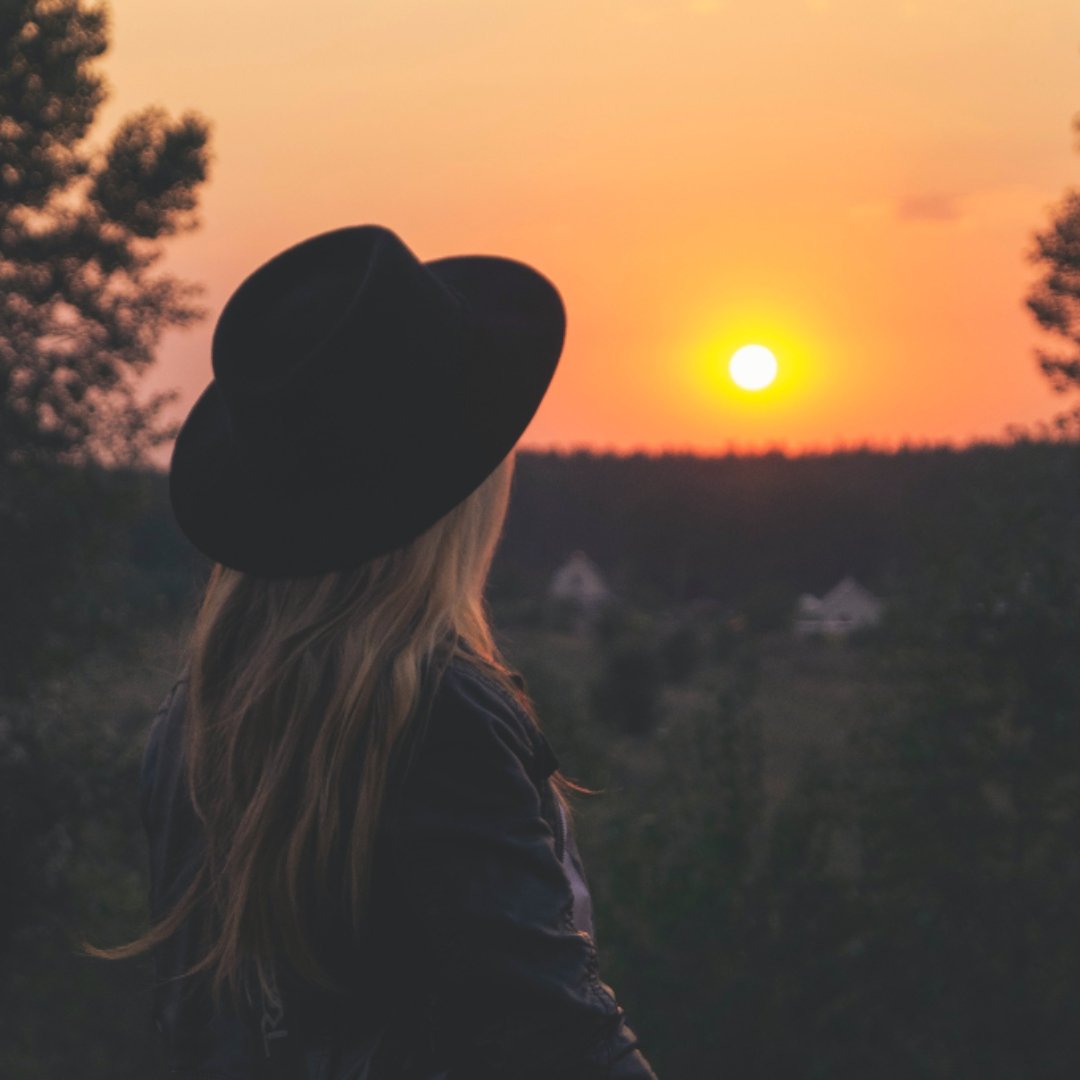 woman looking at a sunset