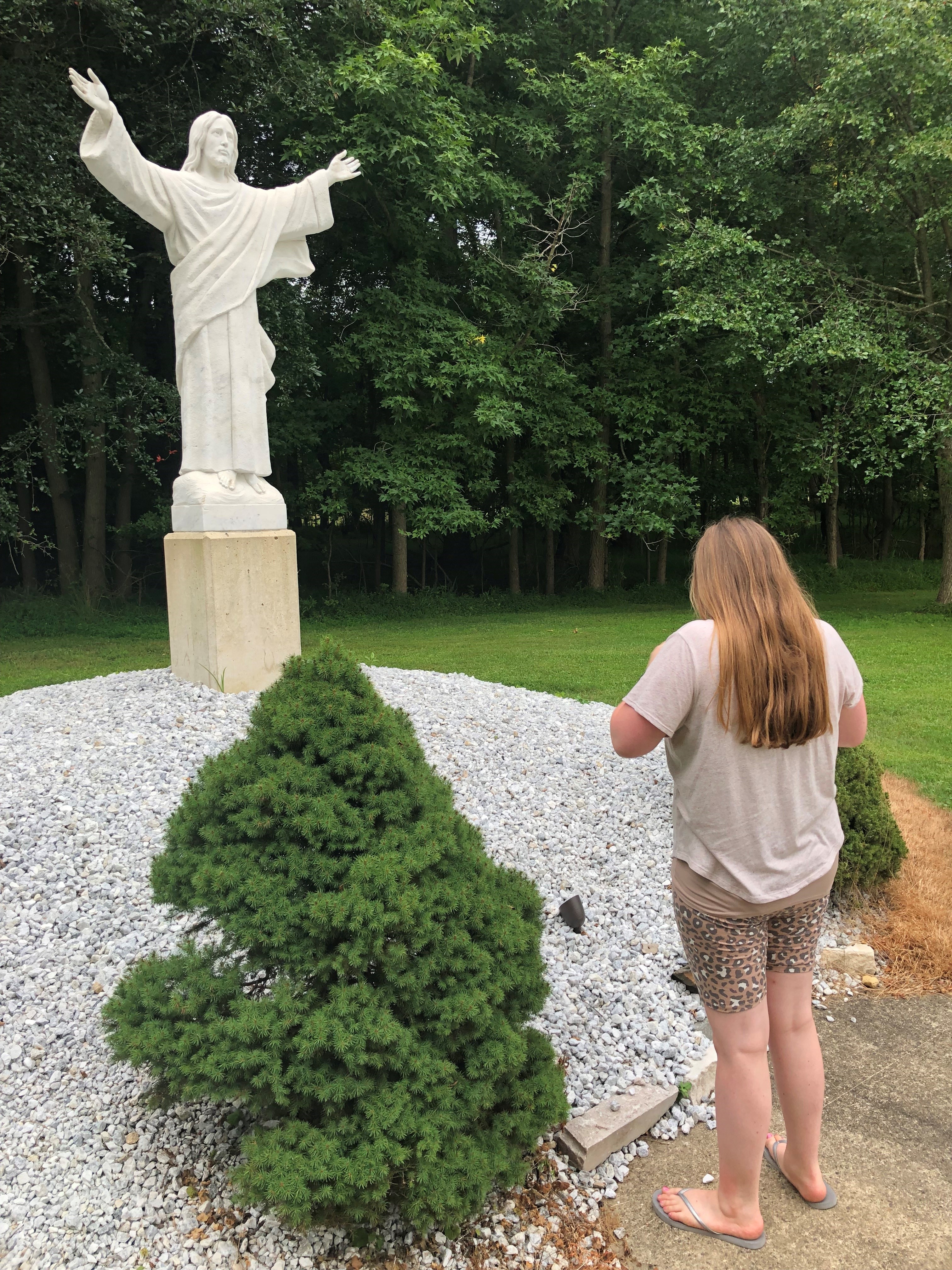 Danielle Rizzo in front of statue of Jesus