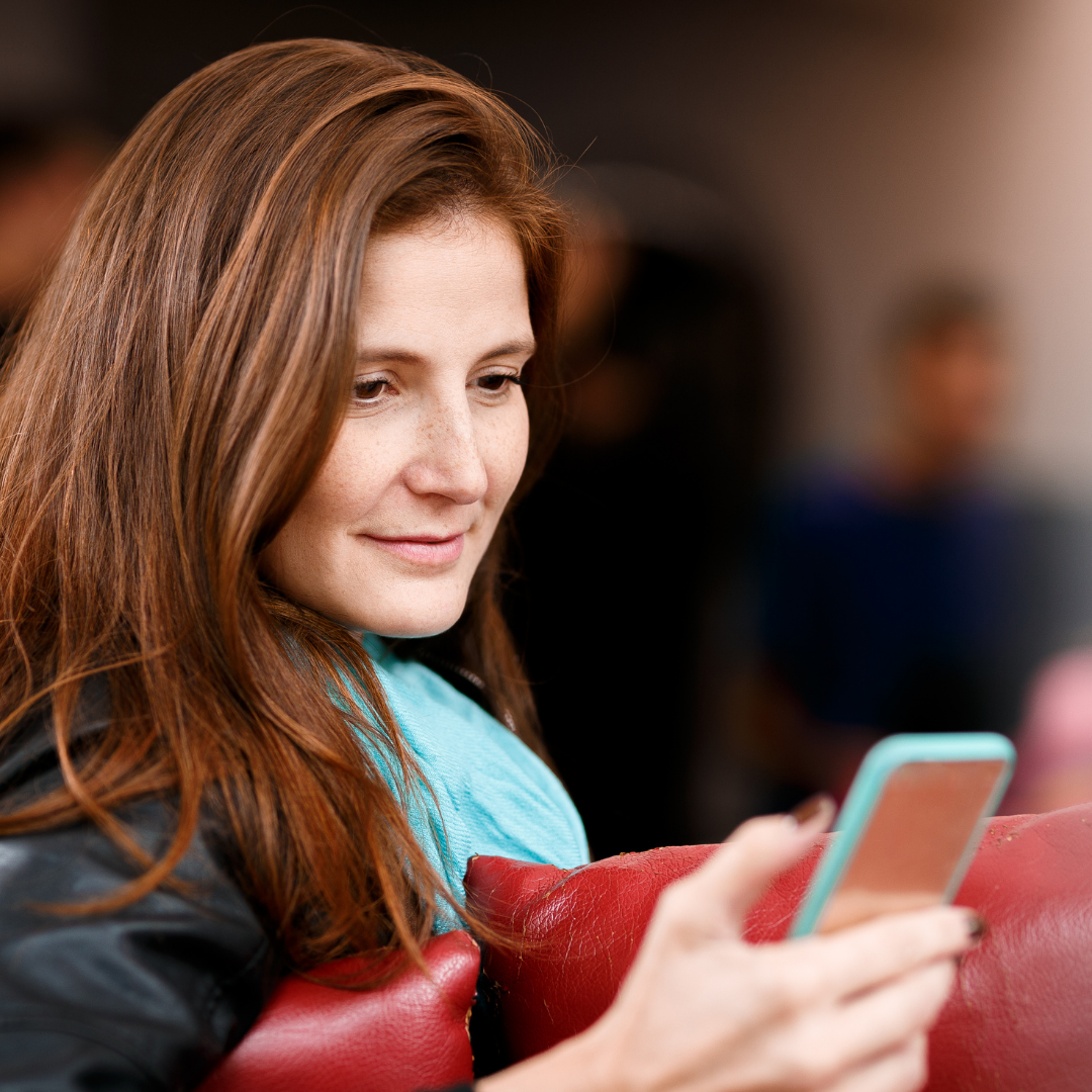 woman looking at cell phone