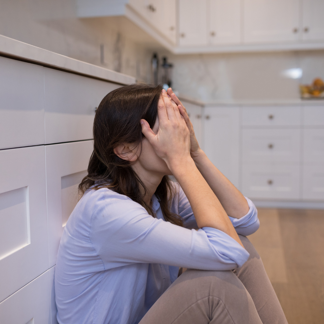 worried woman sitting on the floor