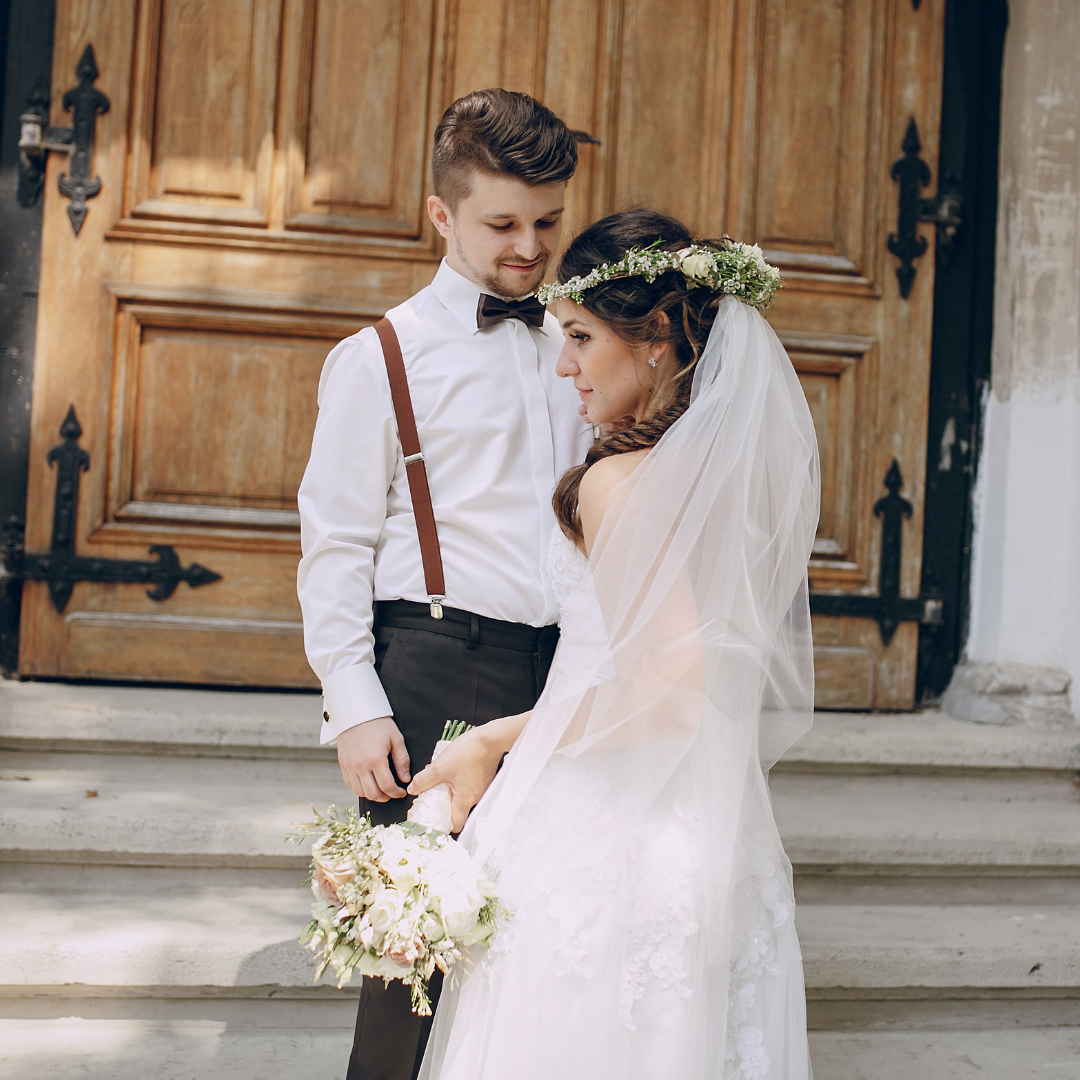 bridge and groom on steps of a church