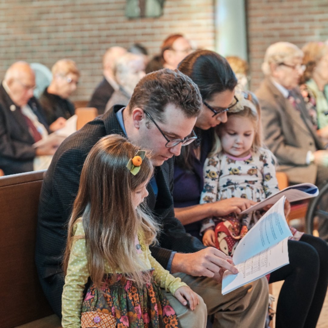 parents with 2 small children at Mass