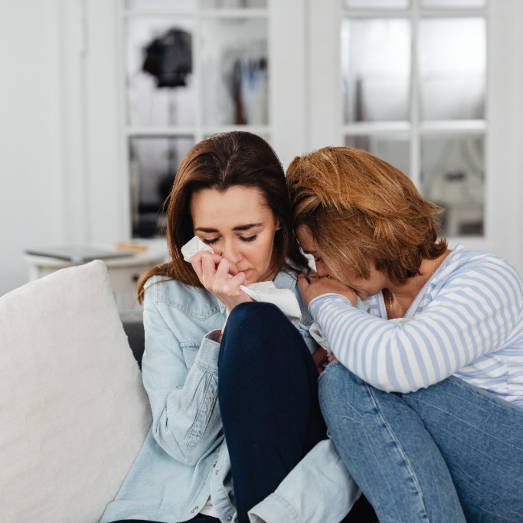 2 women crying together