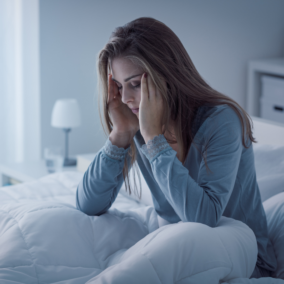 woman sitting up in bed, awake