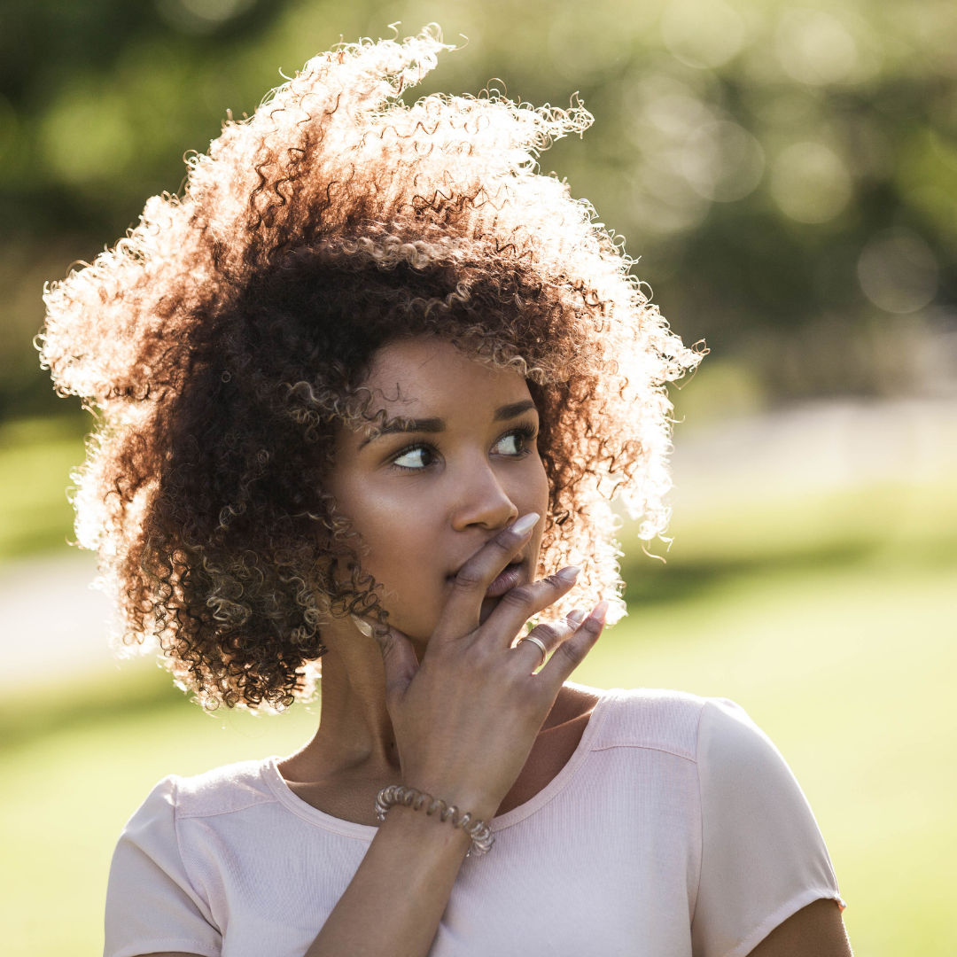 woman covering her mouth in fear