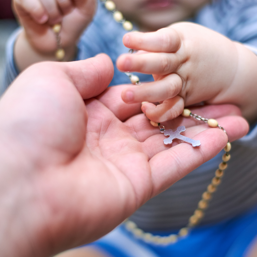 mother and baby with Rosary