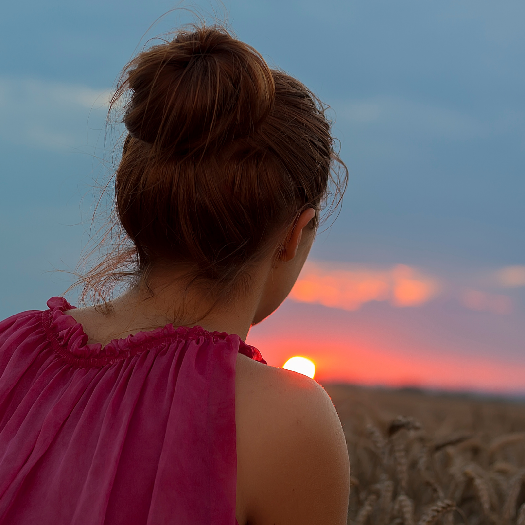 woman looking at a sunset view