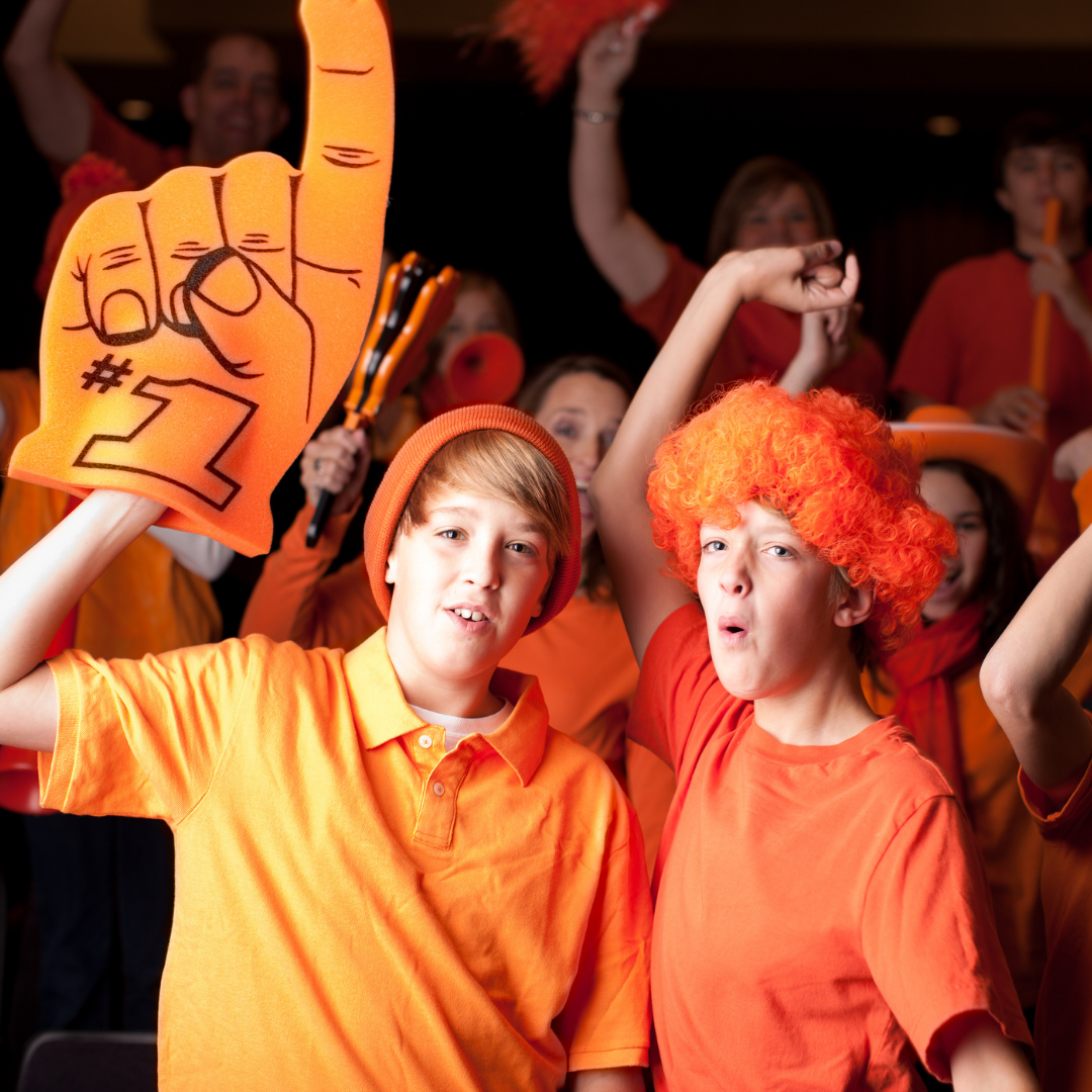 kids dressed in orange fan gear