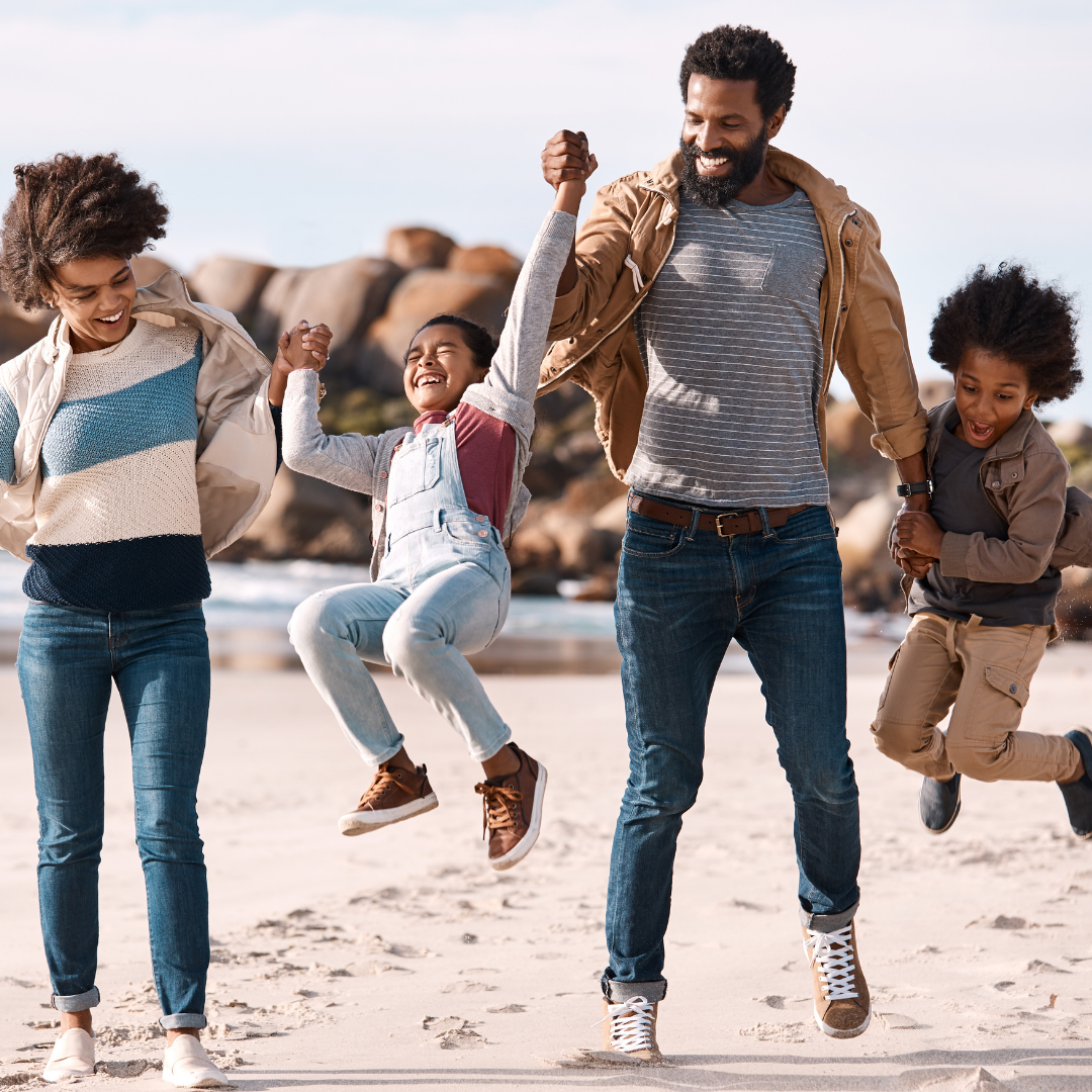 kids jumping in the air, holding parents' hands