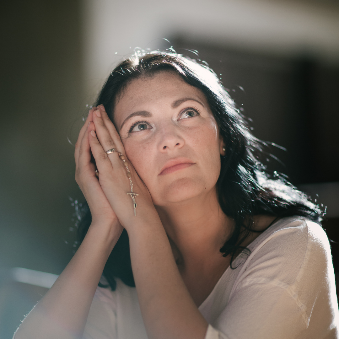 woman praying with Rosary