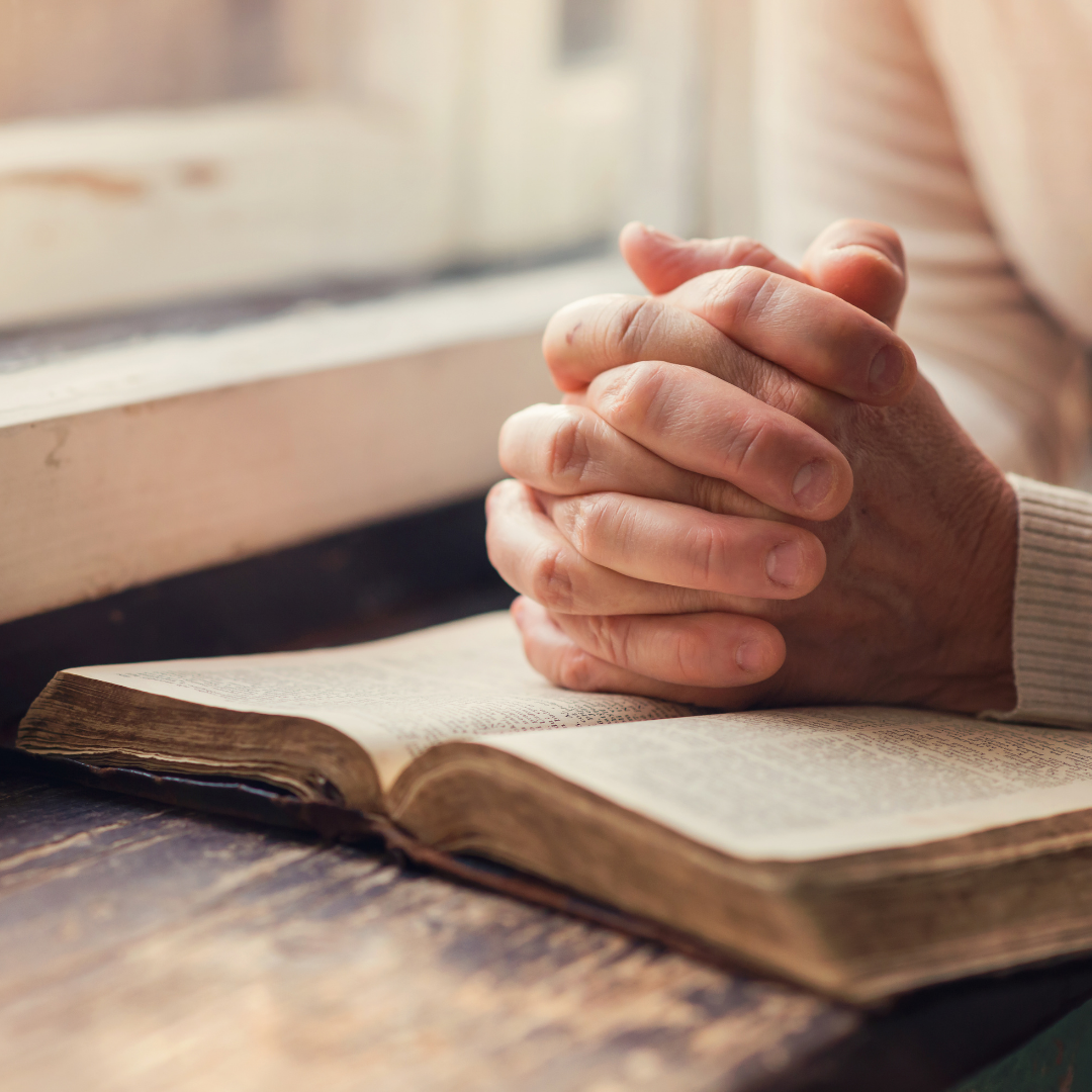 woman holding a bible and praying