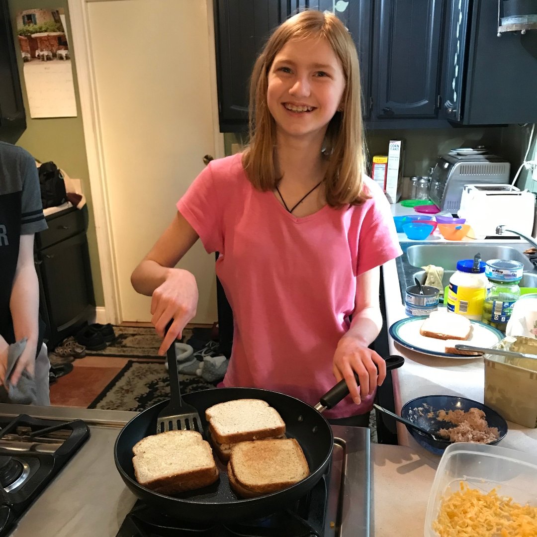 girl making grilled cheese sandwiches