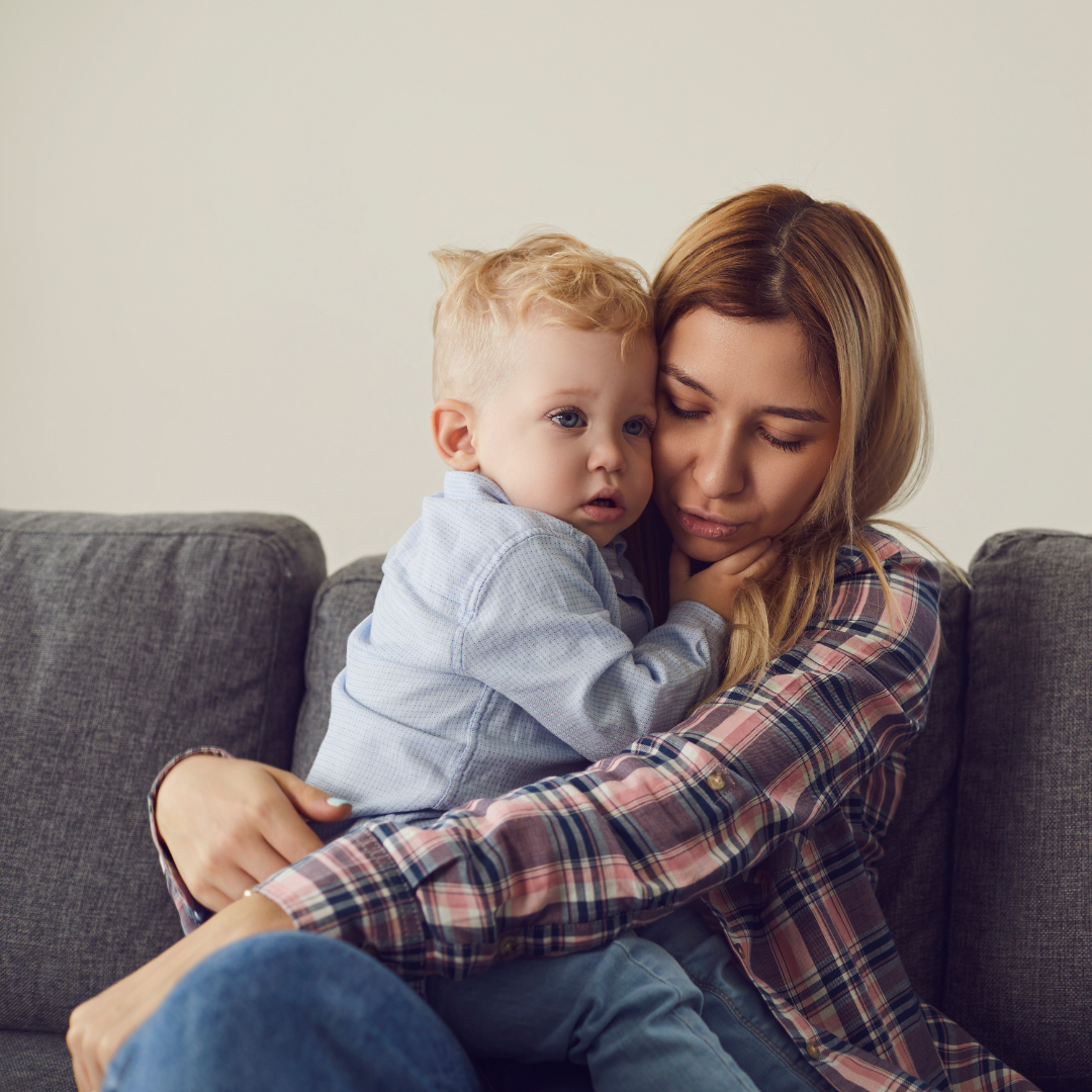 mother consoling sad toddler