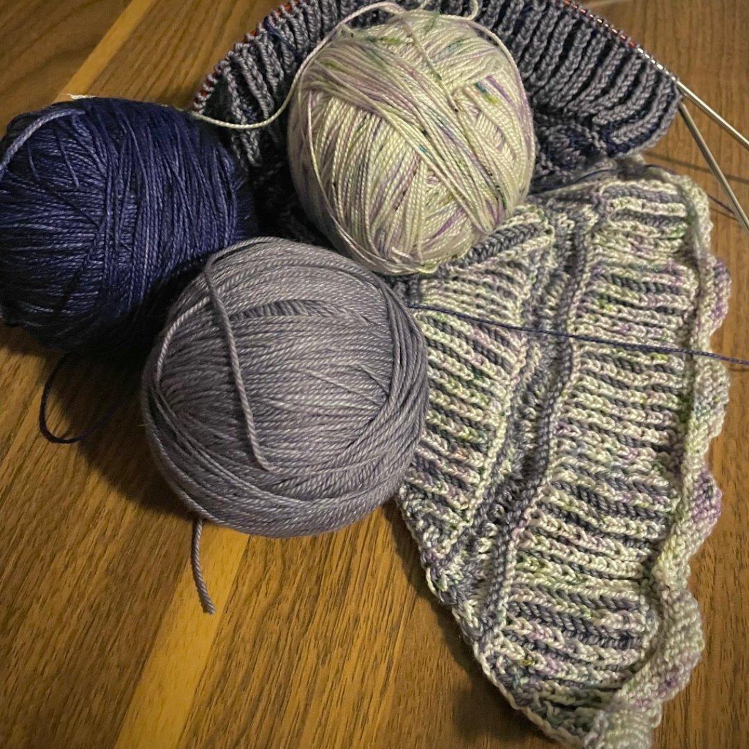 3 balls of yarn and knitted projects