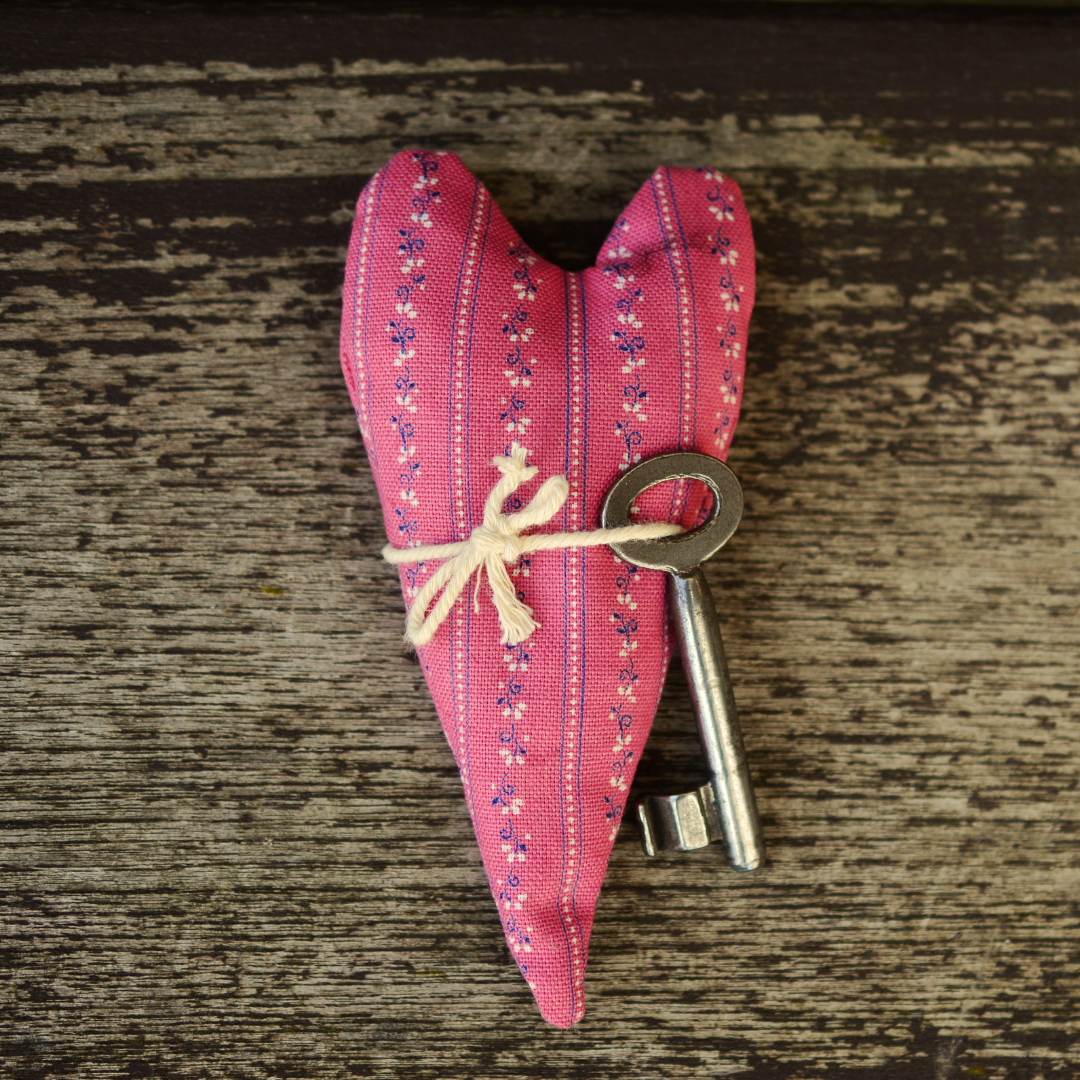 red quilted heart with skeleton key tied around it