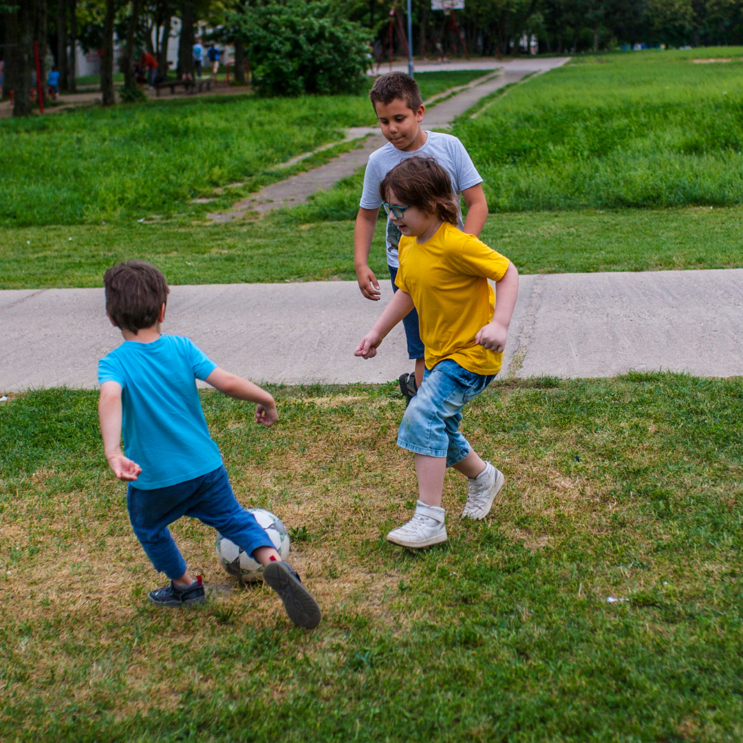 children playing soccer in the yard