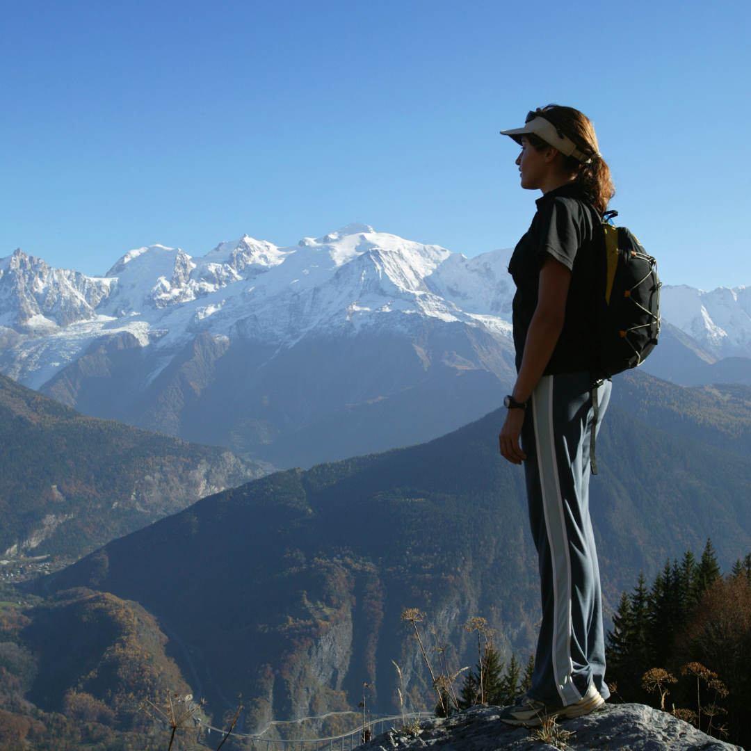 woman standing on a mountaintop