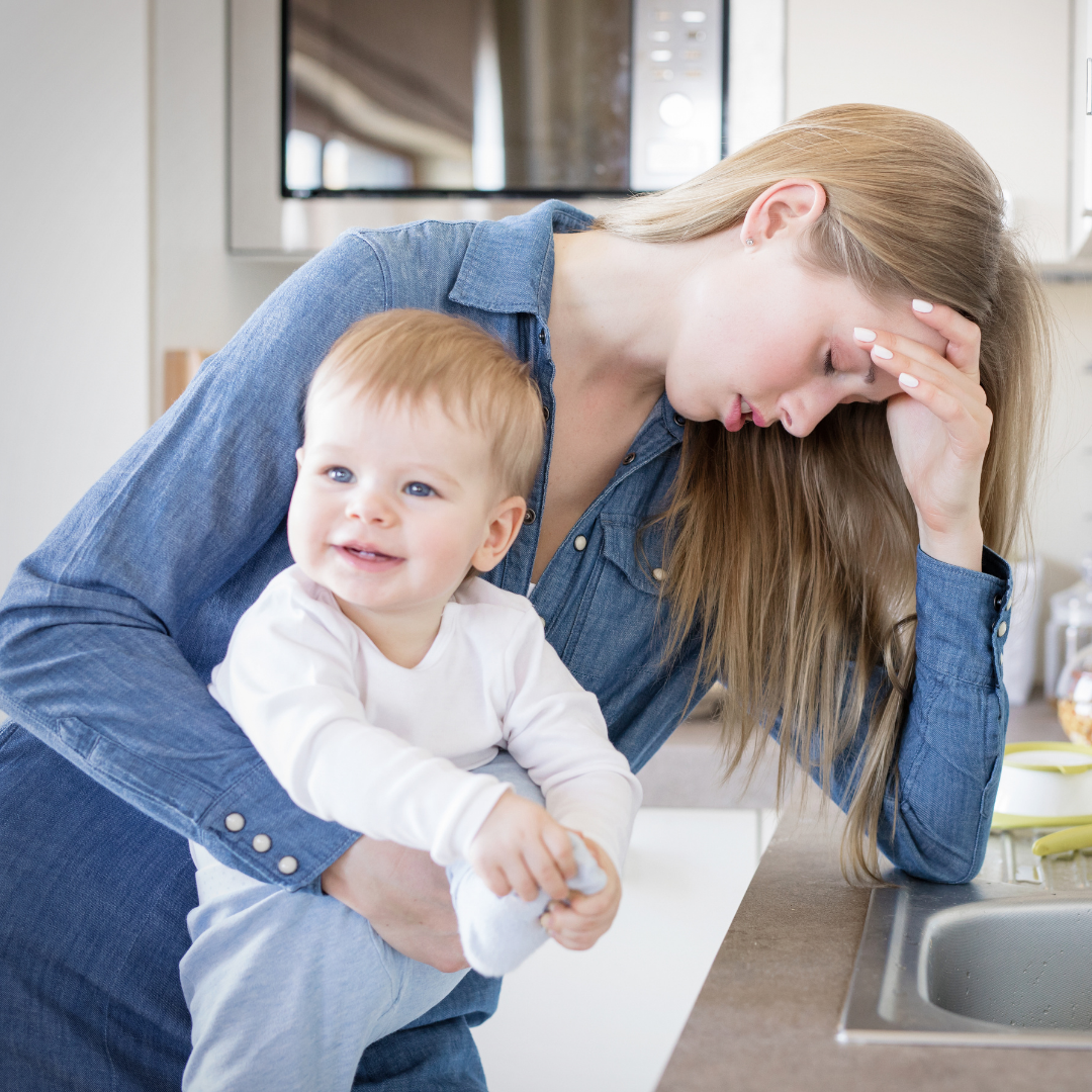 tired mom holding child