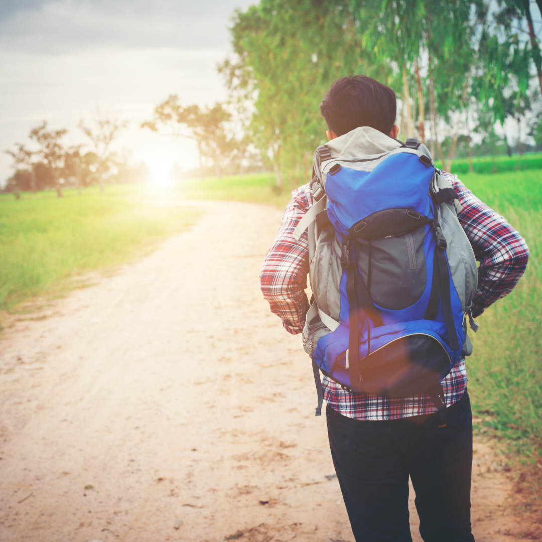 young man wearing backpack, walking away