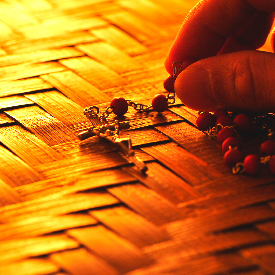 rosary on woven tabletop