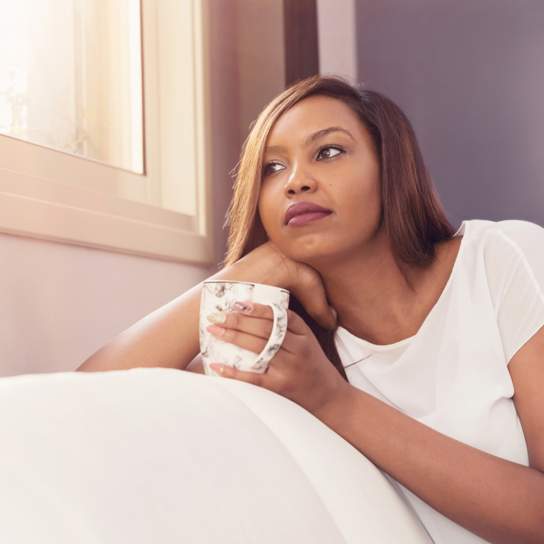 woman thinking and holding a cup of tea