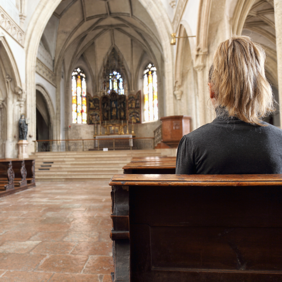 woman praying alone in a church