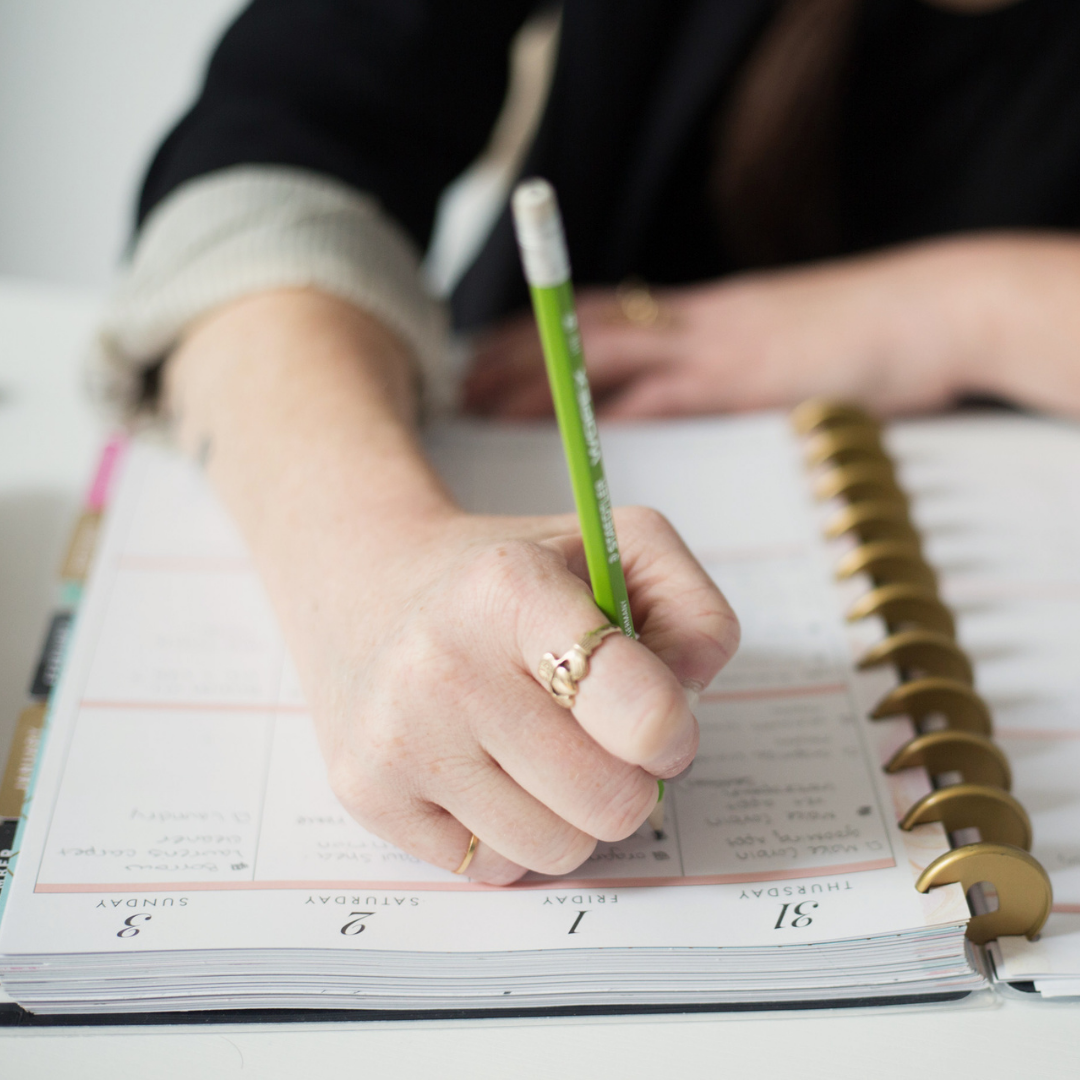 woman writing in planner