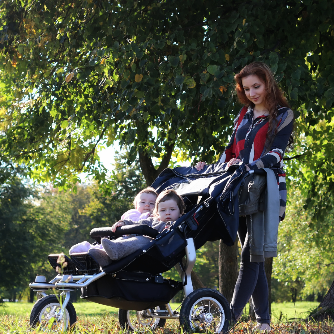 mom walking 2 children in a stroller