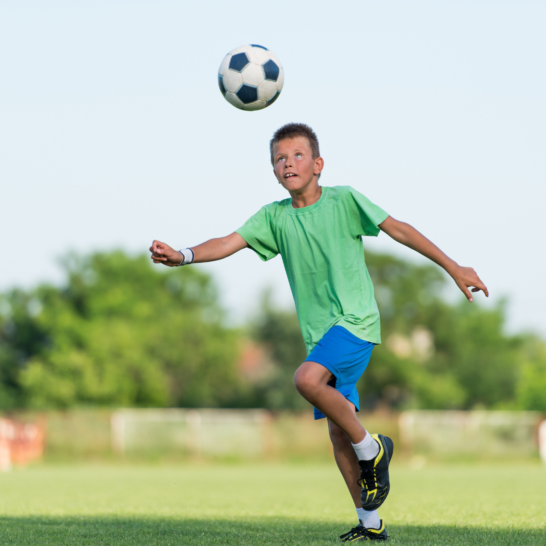 young boy playing soccer