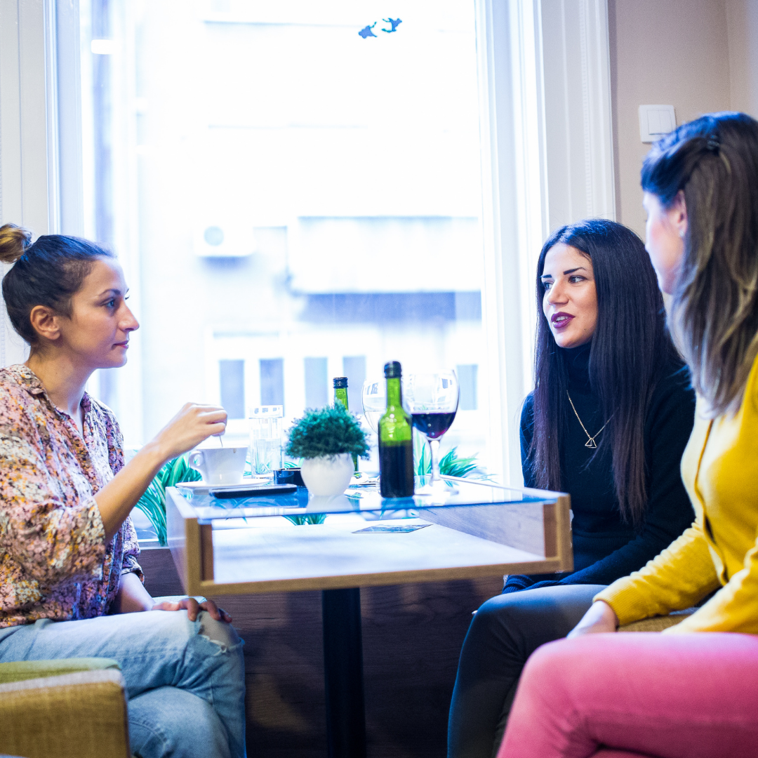 3 moms talking at a table