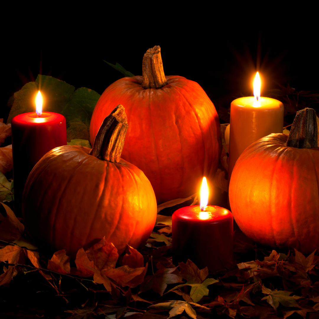 pumpkins, candles, and autumn leaves