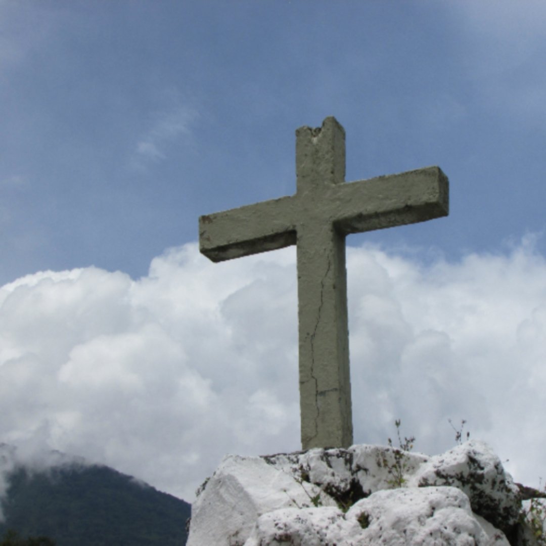 stone cross against a cloudy sky