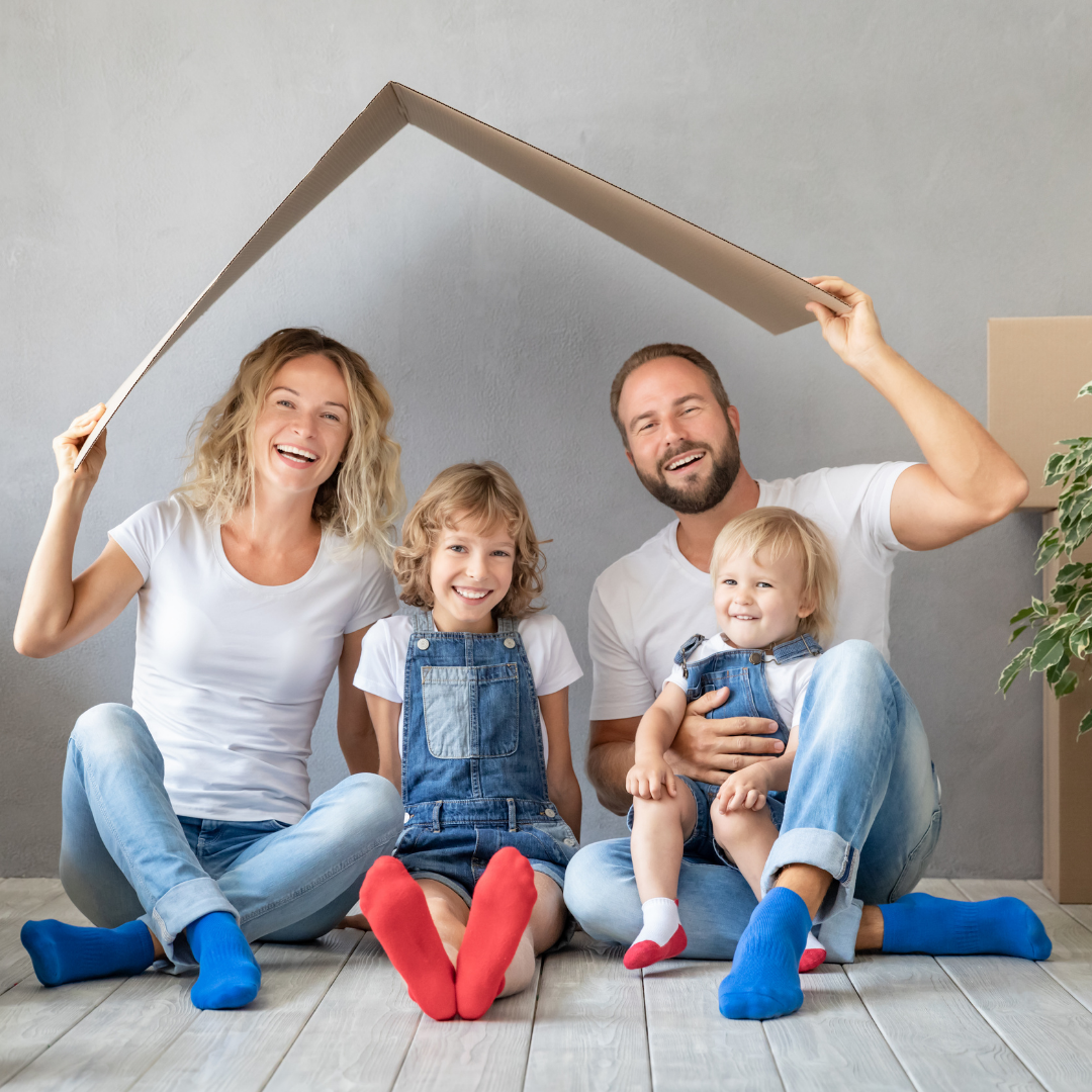 family playing in the middle of moving boxes