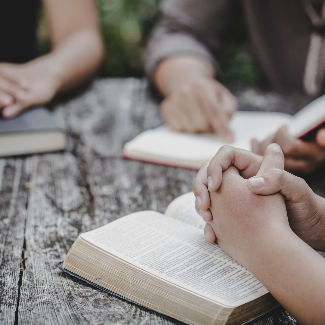 women praying with Bibles