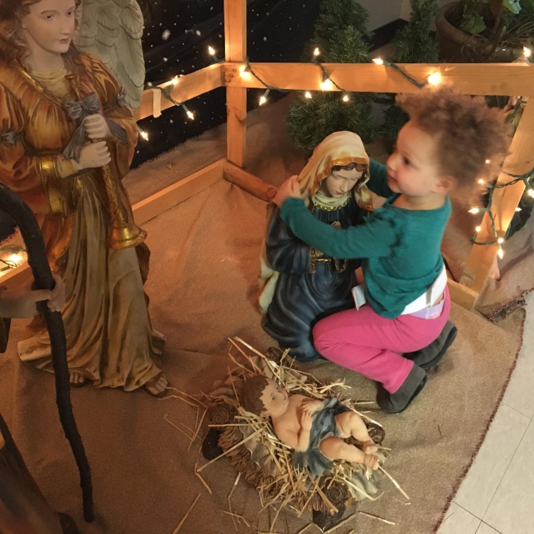 child hugging Mary statue