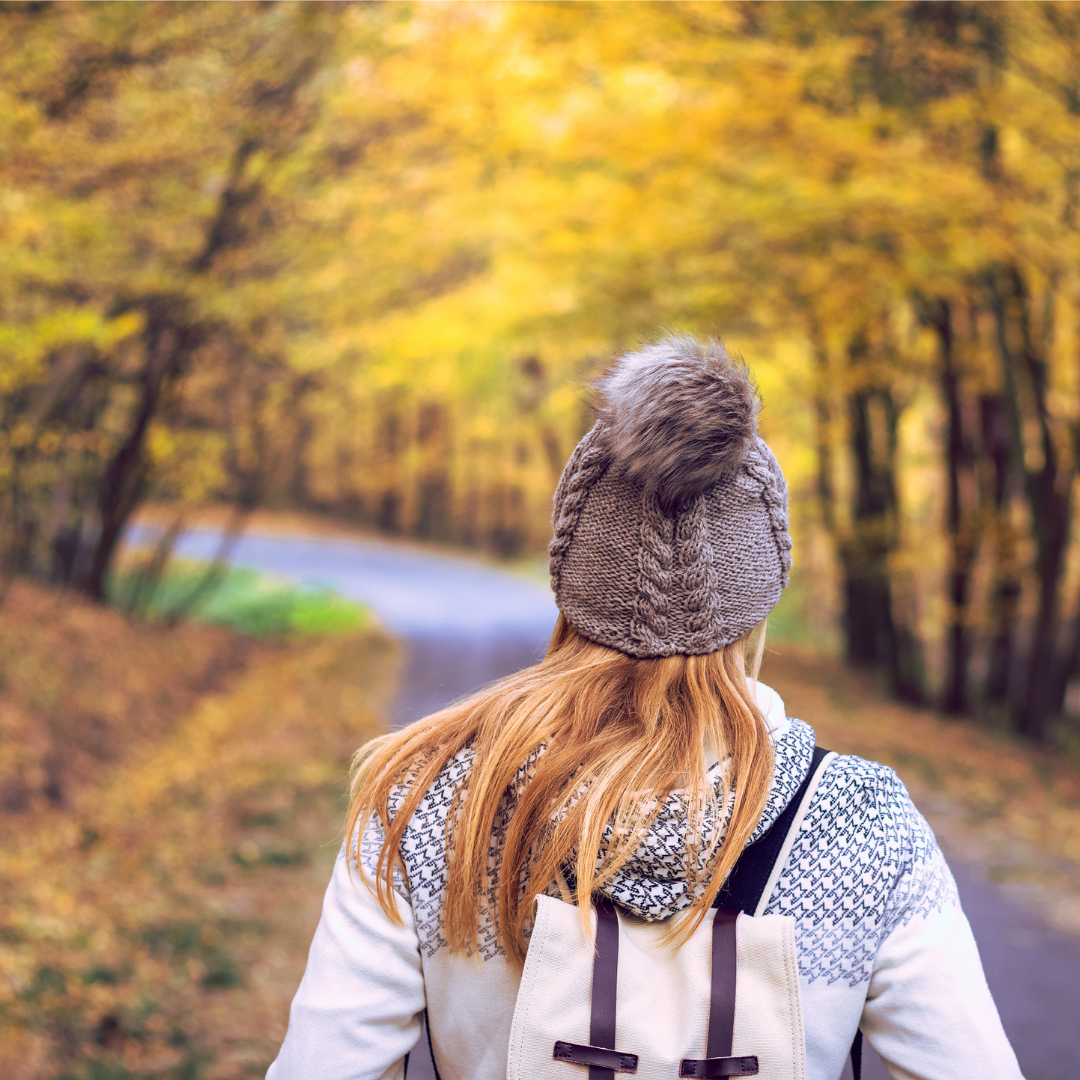 woman walking on a path in autumn