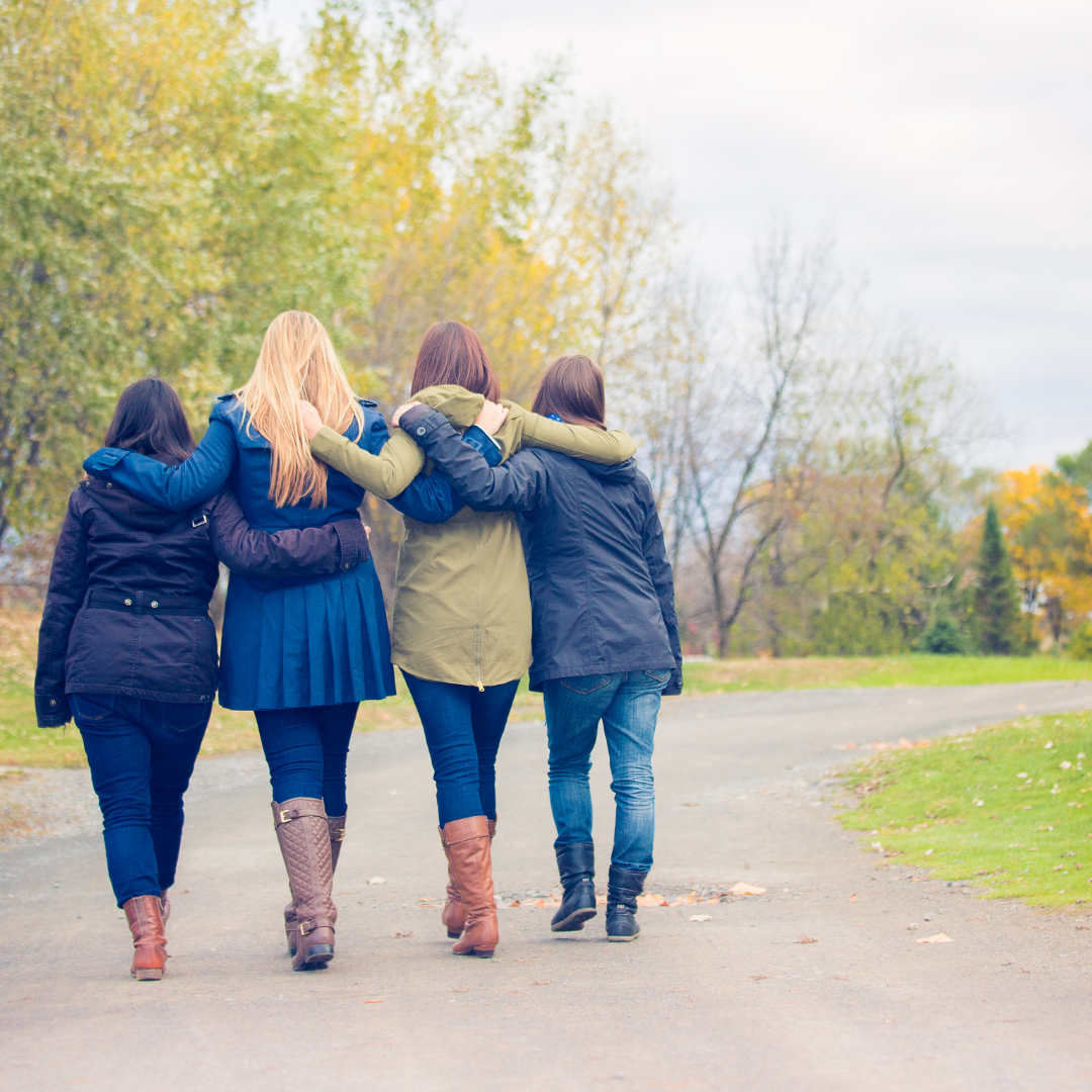 friends walking along a path in autumn