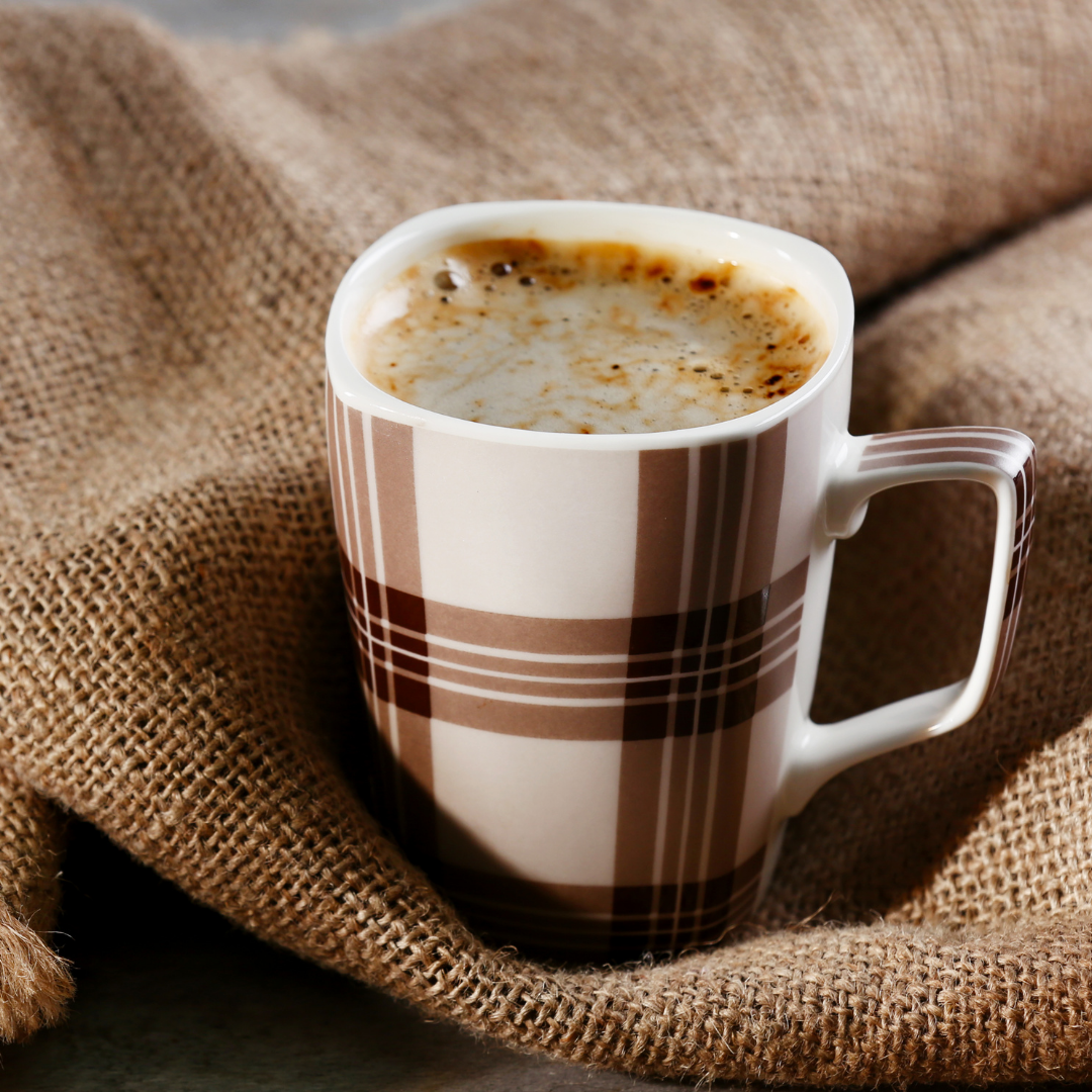 cup of coffee on brown burlap towel