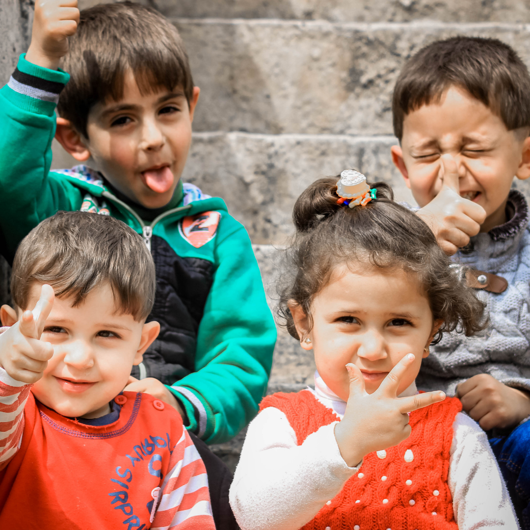 4 children making funny faces