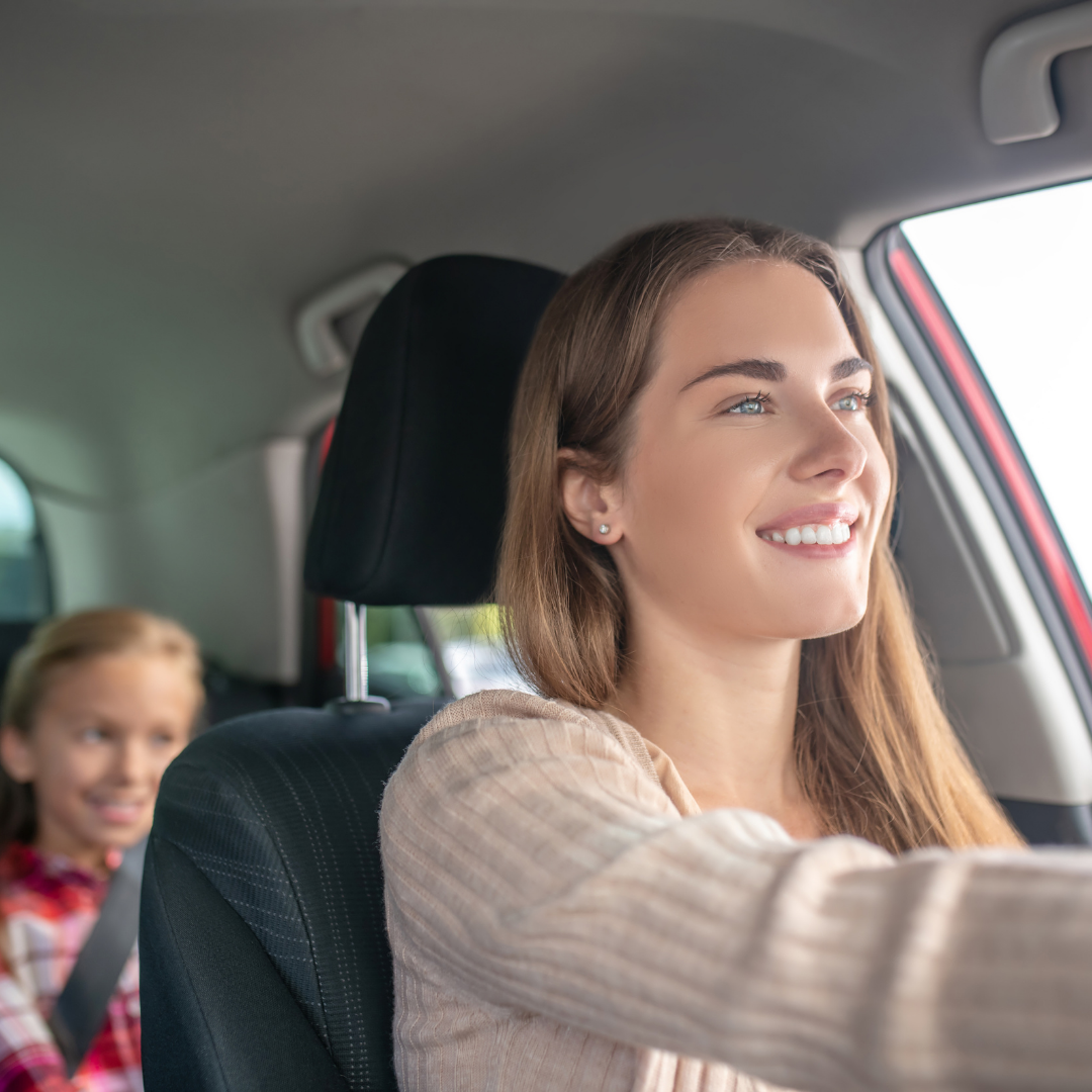 mom driving with child in back seat