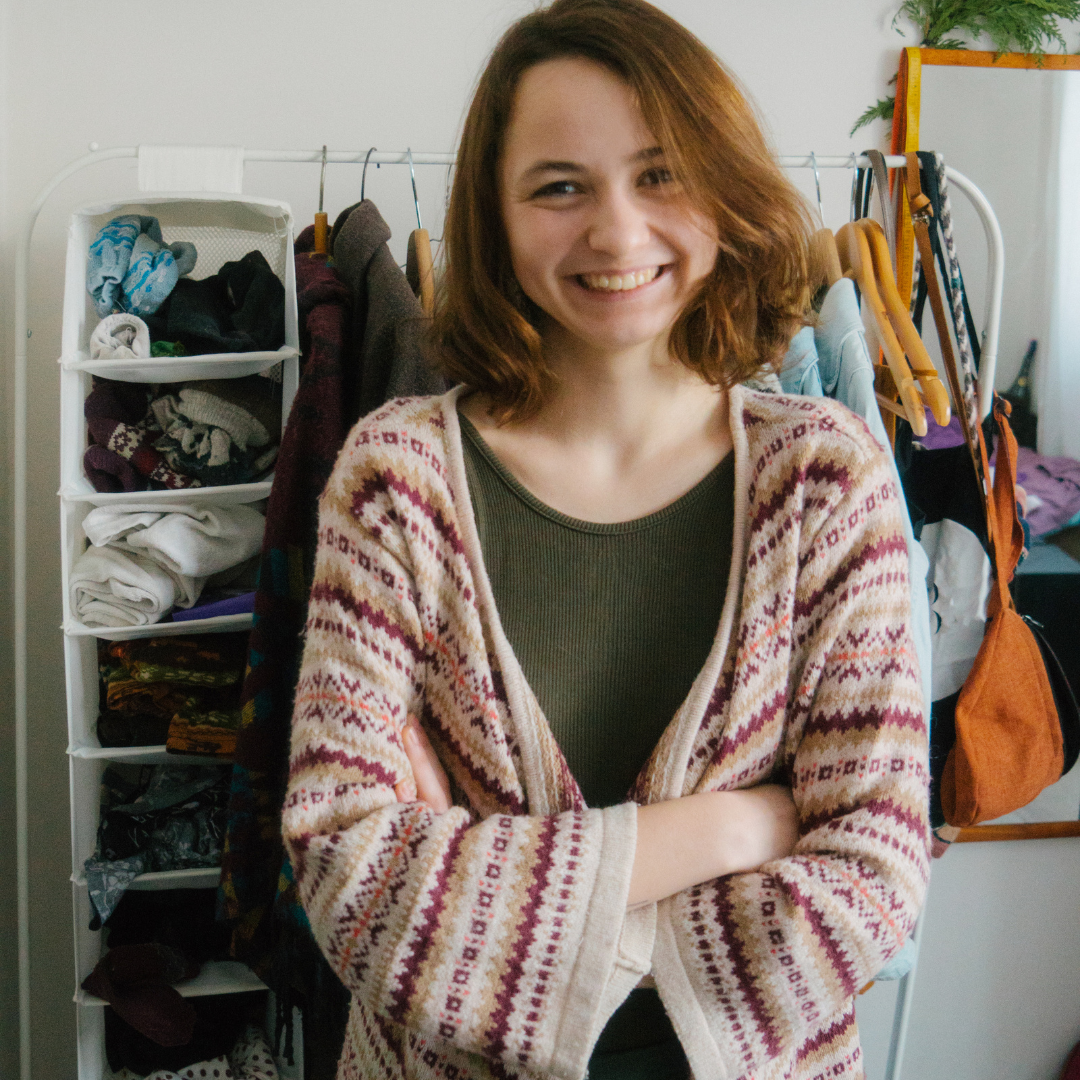 woman in cozy sweater standing in front of closet
