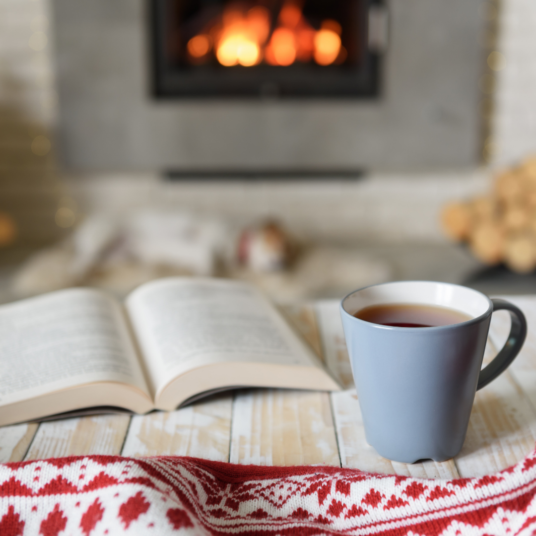 tea and book in front of fireplace