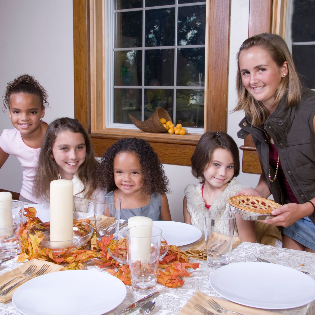 family setting Thanksgiving table