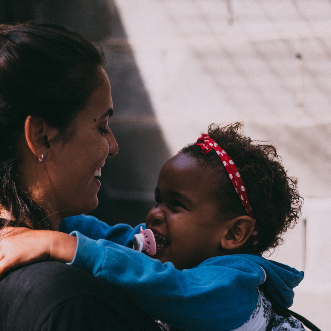 woman hugging small child