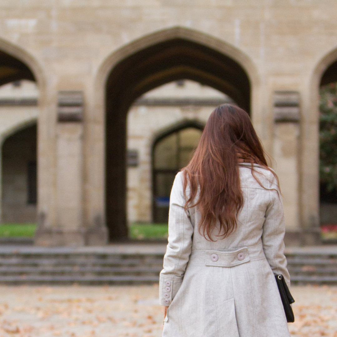 woman walking away through a gate