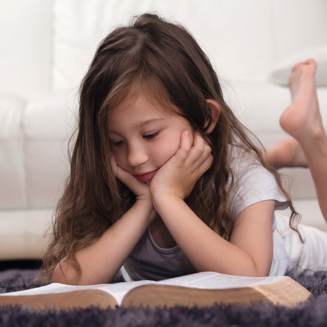 little girl reading Bible