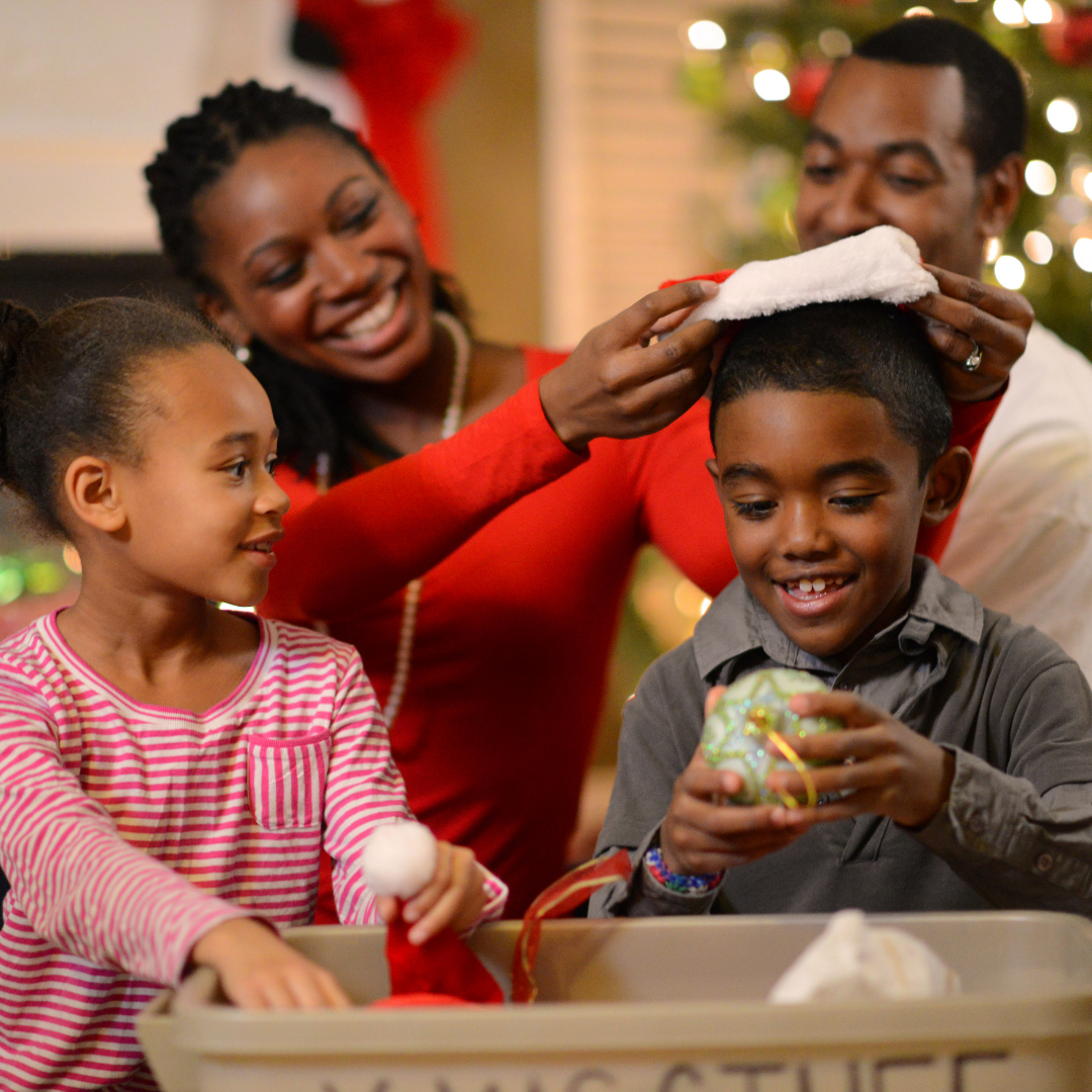 family taking Christmas decorations out of a storage box