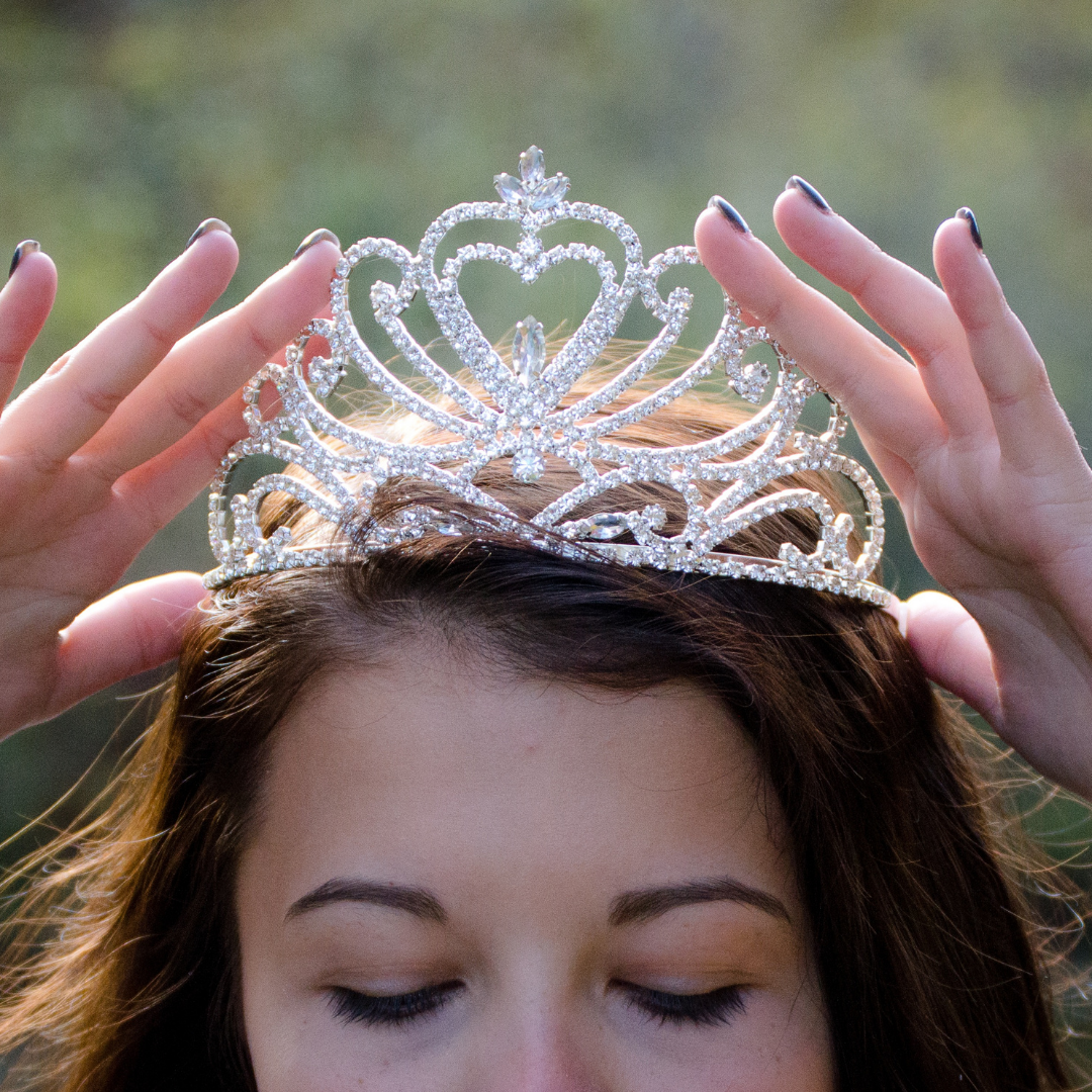 woman putting on a tiara