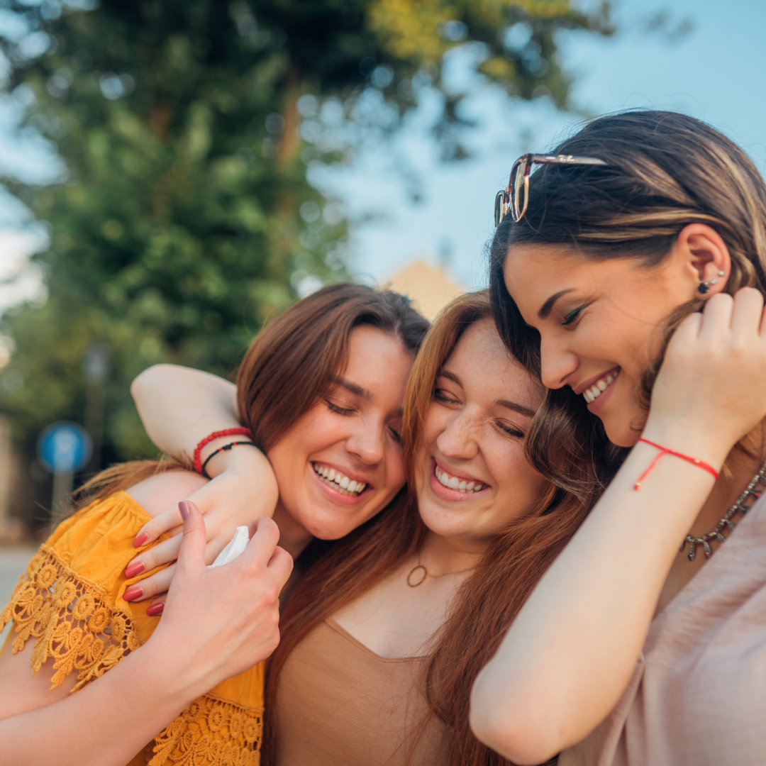 group of 3 women hugging