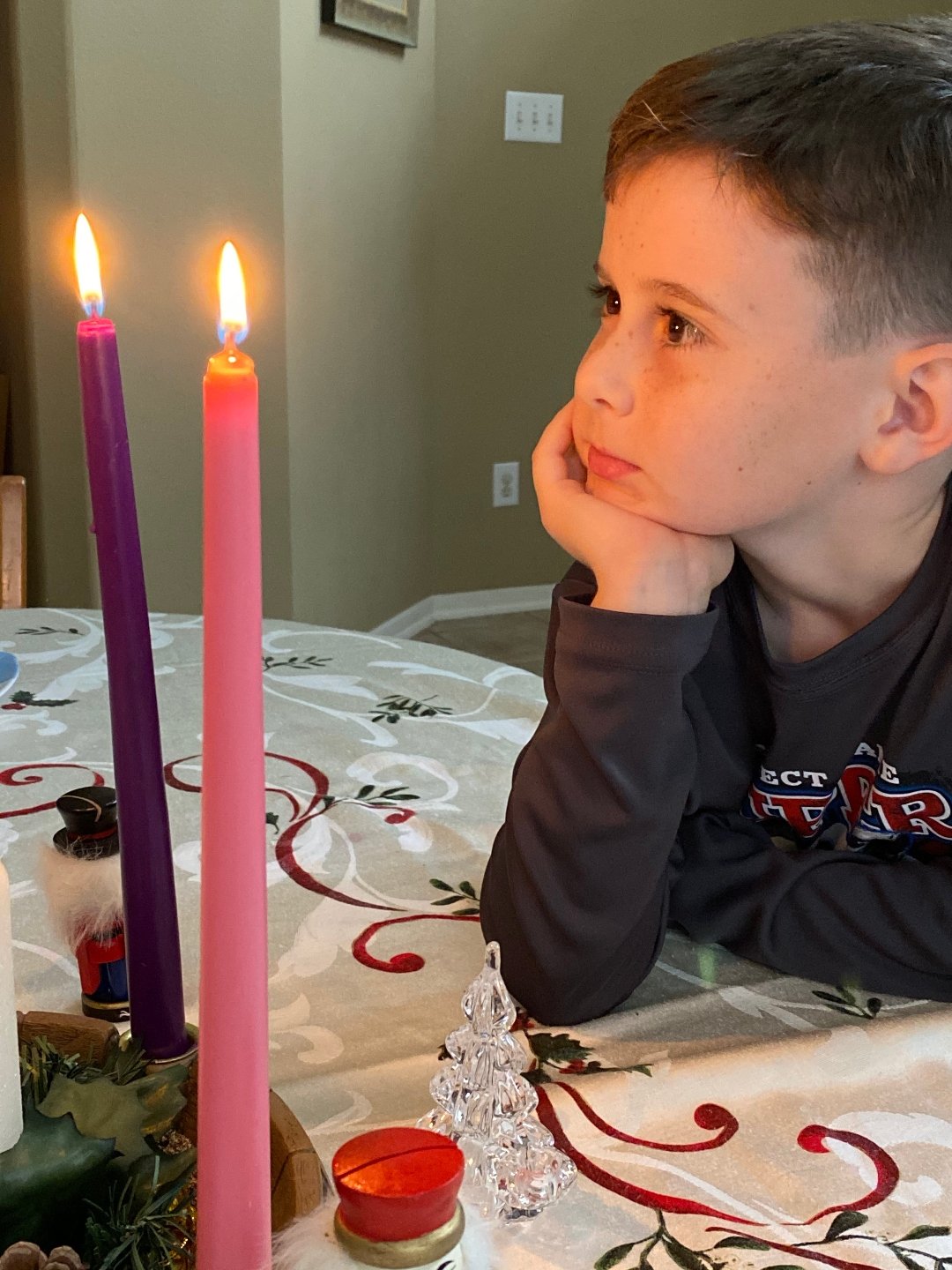 child looking at Advent wreath